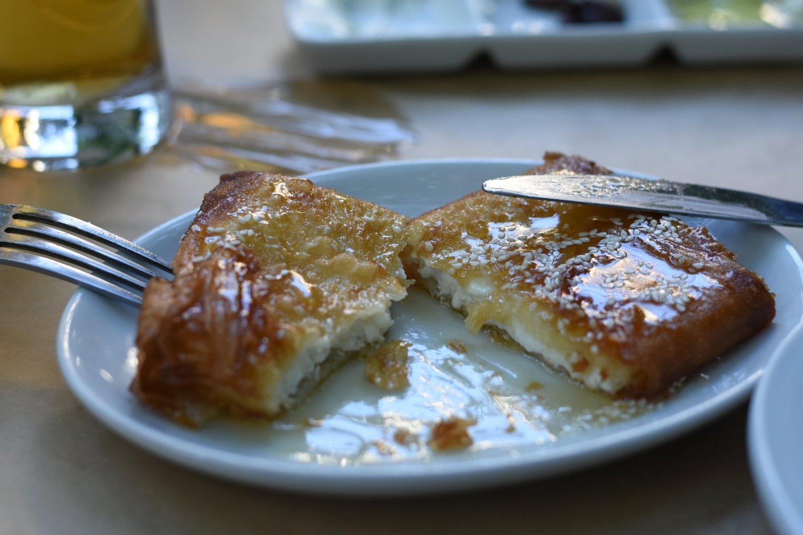 Golden saganaki cheese on a white plate